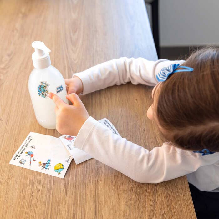 Enfant personnalise sa bouteille rechargeable de gel douche